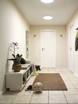 Sun Tunnel (or tubular) skylights in an interior hall, when equipped with optional light kits, provide 24-hour illumination from one source.