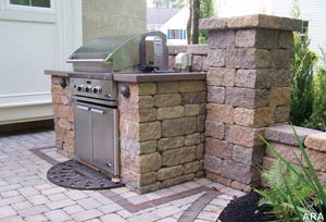 Why cook indoors when you can create your own outdoor kitchen? Solid retaining wall units can be easily cut to fit a grill or refrigerator and topped with a nice stone slab.